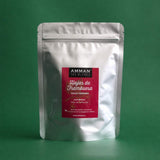 Envase Doypack plateado de Hojas de Frambuesa Amman Tea Blends con etiqueta roja para salud femenina, sobre fondo verde.