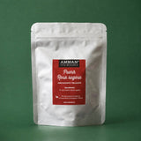 Envase Doypack plateado de Té Rojo Puerh Rosa Rugosa Amman Tea Blends con etiqueta roja, adelgazante y relajante, sobre fondo verde.