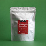 Envase Doypack plateado de Rosa Mosqueta Amman Tea Blends con etiqueta roja, desintoxicante y antioxidante, sobre fondo verde.